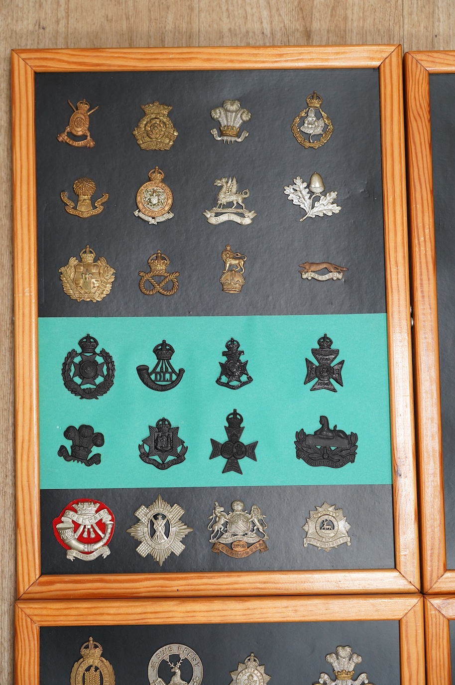 A collection of ninety-seven military cap badges mounted on four boards including; The City of London Yeomanry, Duke of Lancaster‘s Own, Bedfordshire Regiment, Leicestershire Regiment, Seventh Battalion Hampshire Regimen